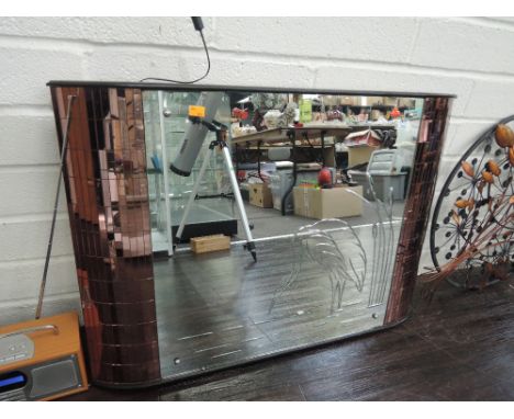 A vintage mirror with peach mirror tiles to sides and Heron decoration