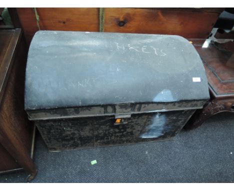 A vintage dome top tin trunk