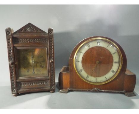 A Smith Sectric mahogany cased mantel clock and an oak cased mantel clock with carved decoration. [2]