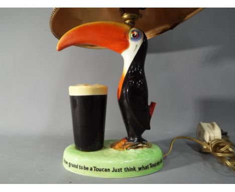 A Carlton Ware Guinness toucan lamp with shade, approximately 39 cm (h) including shade.