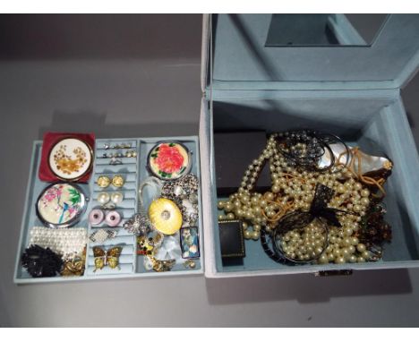 A modern light blue suede two-layered jewellery box containing a quantity of modern and vintage costume jewellery to include 