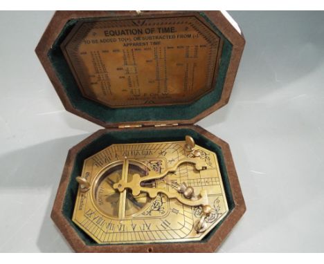 A brass sundial compass marked  Cox, London, boxed