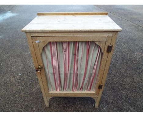 A continental styled pine or light wood larder cupboard with two opening doors and single shelf interior, 60cm x 36cm x 88cm