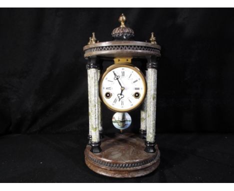 A circular, 6-pillar portico or tholos style mantel clock in contrasting green and brown marble, white enamel dial with Roman