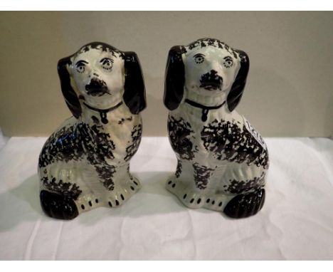 Pair of 19th Century Staffordshire spaniels, H: 18 cm, crack to one crazing and signs of age throughout. P&amp;P Group 2 (£18