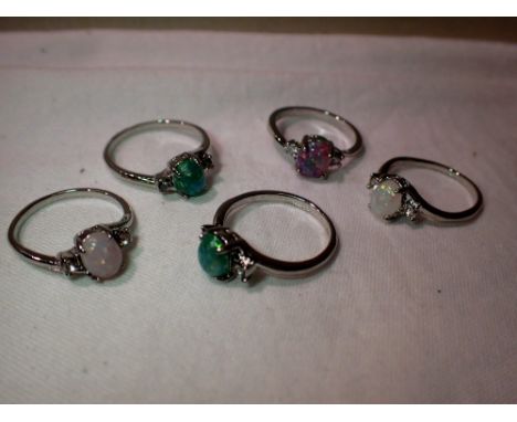 Five presumed silver rings set with opalescent stones in vintage jewellery bracelet box. P&amp;P Group 1 (£14+VAT for the fir