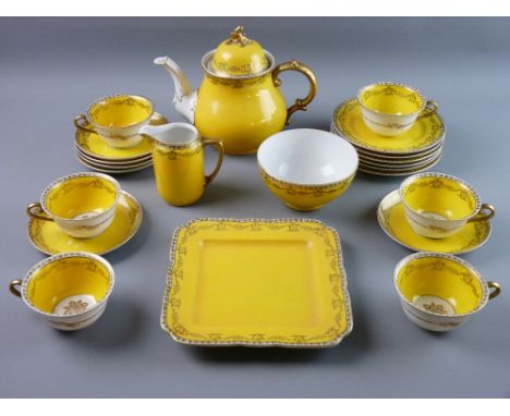 A TWENTY TWO PIECE KPM BERLIN PORCELAIN TEASET, yellow ground with wreath and floral swag gilt decoration comprising sandwich