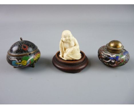 A JAPANESE IVORY NETSUKE of a seated figure and two miniature cloisonné containers, one an inkpot and the other a lidded pot 