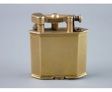 A NINE CARAT GOLD ENGINE TURNED DUNHILL CIGARETTE LIGHTER of oblong form with angled corners, 32 grms gross