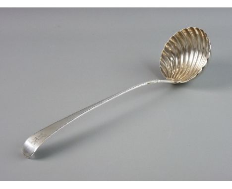 A FINE SILVER SOUP LADLE, the 9 cms bowl of shell form and the tapered handle having feather edging and with a lion crest, to