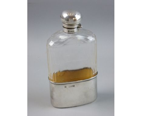 A HEAVY GLASS HIP FLASK with oval gilt silver holder, 2.6 troy ozs, London 1897 and with mushroom shaped silver hinged lid an