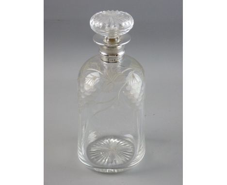 A CUT GLASS DIMPLE SHAPED DECANTER WITH SILVER COLLAR, the body cut with grape and vine leaf decoration, starcut base and mat