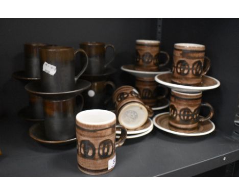 A collection of Cinque port and rye pottery coffee cups and saucers.