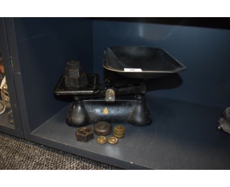 A set of vintage kitchen balance scales with weights