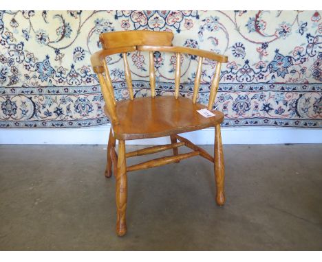 An Edwardian light elm smokers bow chair - in clean polished condition 