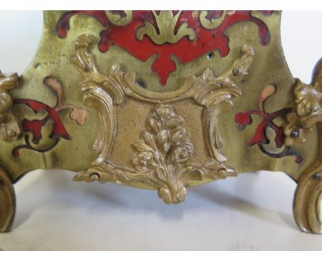 A French 8 day Boulle style clock, the ebonised case gilt decoration to front, showing a ceramic dial painted with flowers an