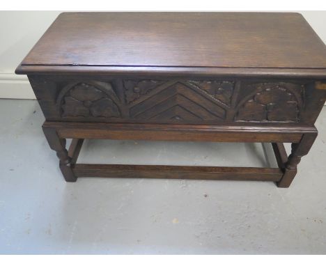 A carved oak stool with lift up top - 41cm H x 66cm x 30cm 