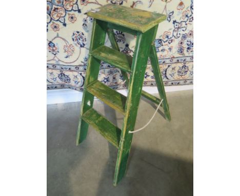 A Vintage three tread ladder in old green paint, waxed for decorative use 