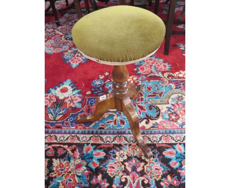 A 19th Century piano stool in a tripod base 