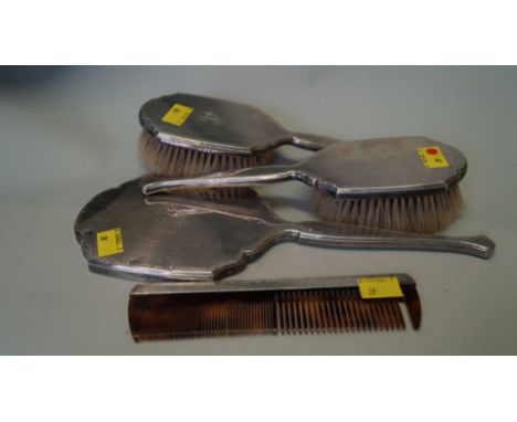 A silver four piece dressing table set, London 1962, comprising two hair brushes; a mirror and a comb.