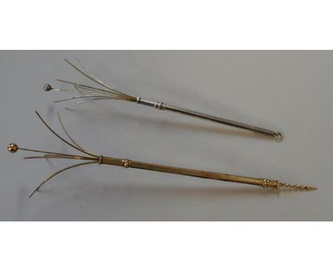 A 9ct gold engine turned swizzle stick, 5.9g; together with a silver example.