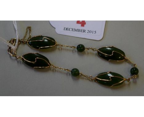 A 9ct gold and jade bracelet.