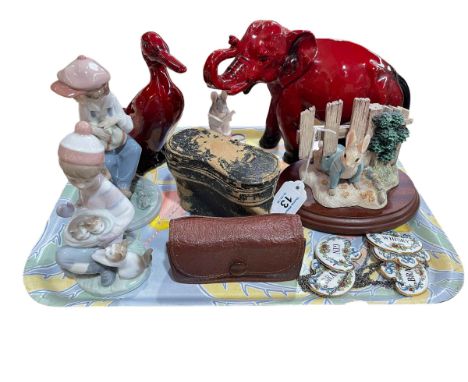 Royal Doulton Flambé elephant and duck, two Lladro figures, two Beatrix Potter groups, five china decanter labels and two pai