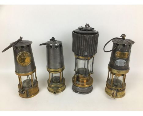 A collection of 19th and early 20th century miner?s lamps, including two marked ?The Protector Lamp & Lighting Co?, also ?104