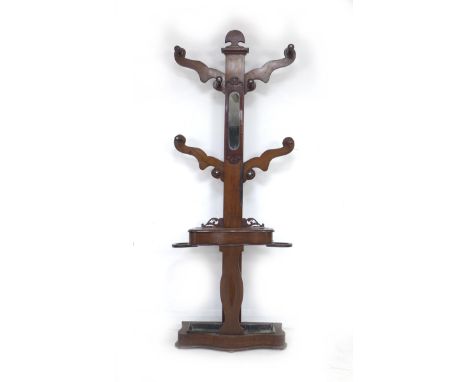 A Victorian mahogany hall stand, the shaped upright with four arms and eight turned pegs, glove compartment, stick and umbrel