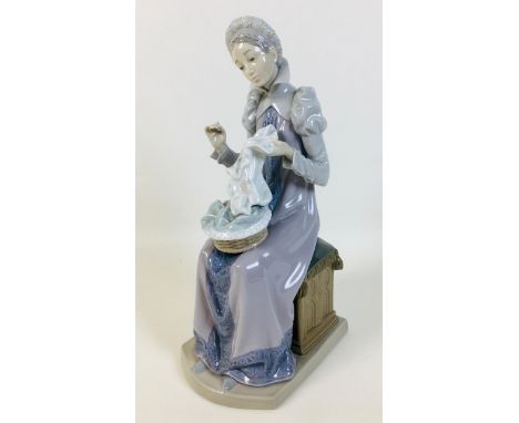 A Lladro 'Seamstress' figurine, 11 by 14.5 by 28.5cm high. 