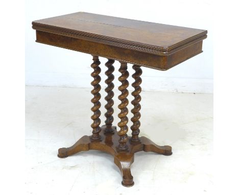 A 19th century burr walnut veneered card table, fold over surface with green baize, raised on four spiral twist columns on a 