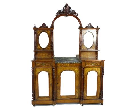 A late Victorian walnut veneered and marquetry sideboard, or narrow form, with arched mirror back and carved crest, flanking 