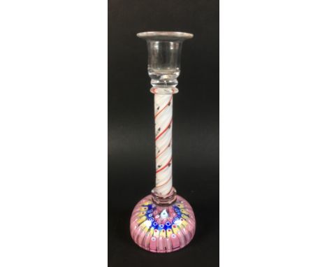 A glass candlestick with candy twist stem in white red and clear glass and millefiore paperweight base, possibly late 19th ce