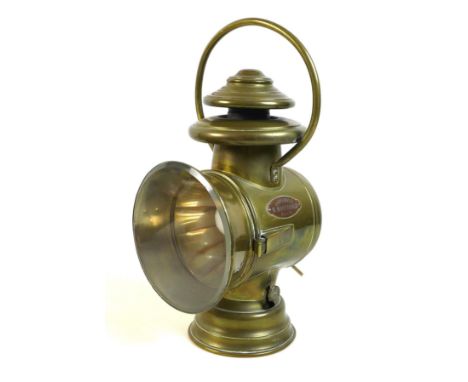 A French early 20th century brass lantern motoring headlamp, later converted to an electric table lamp, circular clear glass 