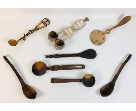 A collection of eight African tribal carved wooden spoons, comprising a double gourd ladle, with limed carved geometric patte
