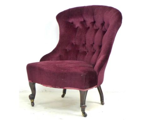 A Victorian nursing chair, bowed button back, serpentine front, upholstered in burgundy velvet, carved scroll front legs and 