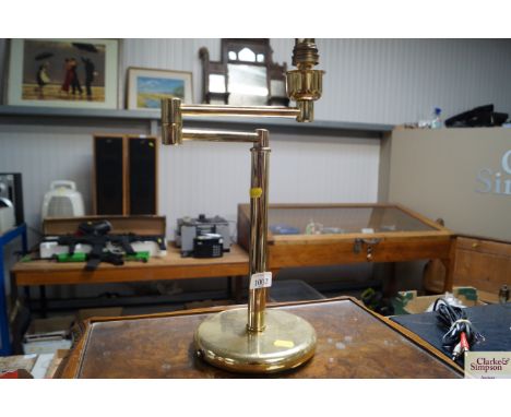 A brass adjustable table lamp 