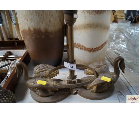 A brass table lamp decorated with swans 