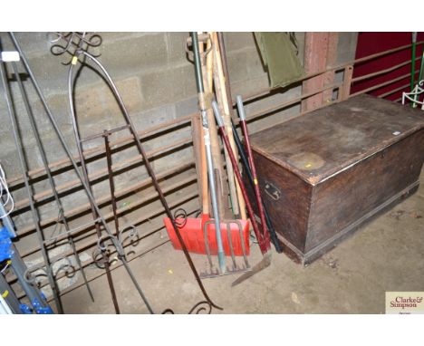 A collection of long handled garden tools; pry bar; snow shovel etc