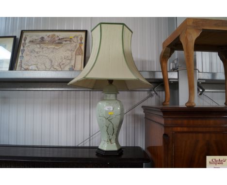 A blossom decorated table lamp and shade