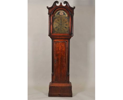 A George III oak cased eight day long cased clock by Winstanley of Holeywell, with a swan neck pediment above reeded free sta