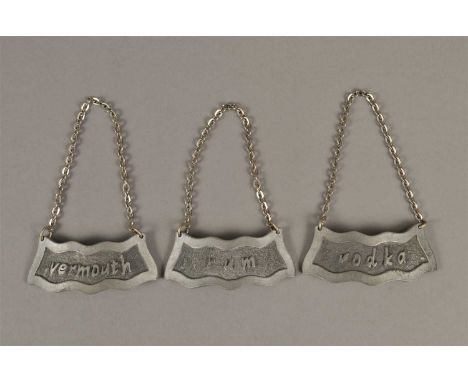 A trio of pressed pewter decanter labels, 'Vodka, Vermouth and Rum', each stamped verso Georg Jensen, Denmark, each 7.5 x 2.5
