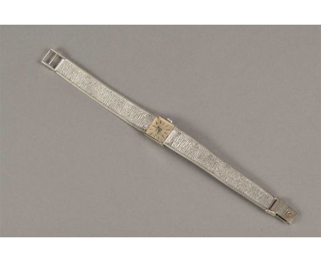 A Ladies White Gold Tissot Bracelet Watch with square case, silvered dial and applied baton numerals. Clasp signed "T" by man