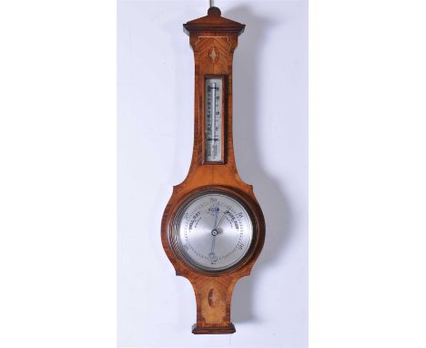 An Edwardian walnut and mahogany cased wall barometer, with a 6" silvered dial and thermometer aperture, 69 x 21.5 cm.