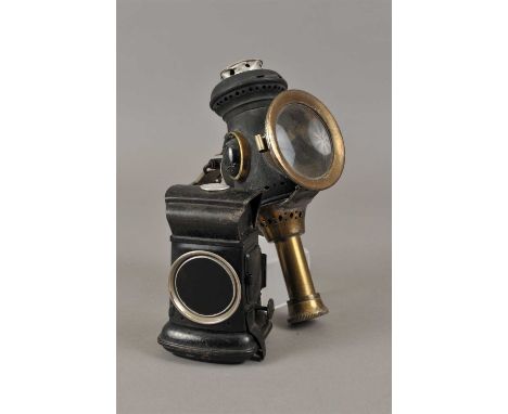 A Lucas oil burning bicycle lamp, fitted with a red glass lense within a blackened case, stampped to top, 12 cm high, togethe