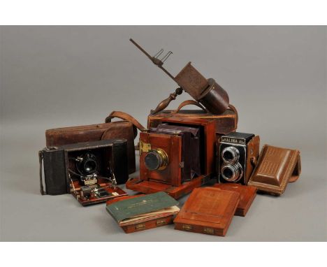 An Edwardian cased mahogany plate camera, on a sliding extending frame, set within a stitched leather case, together with an 