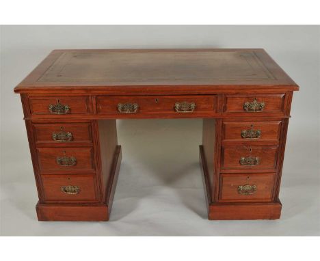 An early 20th century mahogany pedestal desk, with an inset tooled leather top above a central long frieze drawer flanked by 