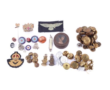 A small group of military buttons and badges. Including enamel RAF WAAF badges, RA aux AF badges, various military buttons, a