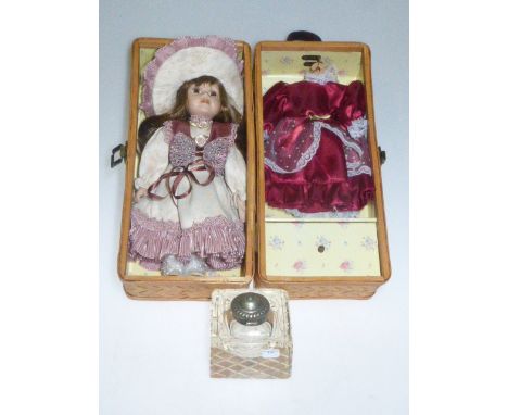 Doll with clothes in wicker box and glass inkwell