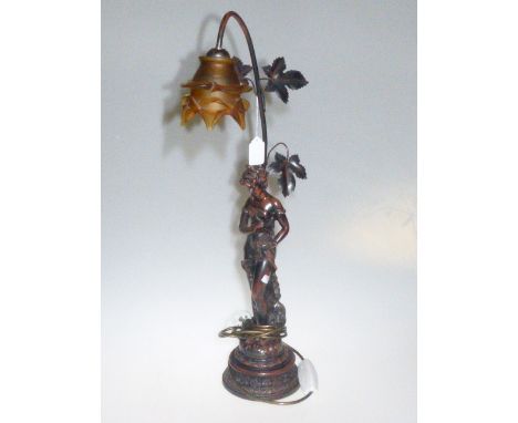 Metal figural table lamp with amber floral design shade